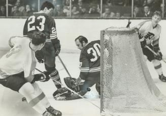 Plight of hapless Leafs is personified in picture as both defenceman Pat Quinn (23) and goalie Bruce Gamble are caught looking wrong way while Philade(...)