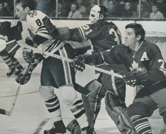 Stop shoving!, Leaf goalie Mary Edwards takes exception to crowding by Black Hawk's Jim Pappin (left) and tries to remove him forceably from screening(...)