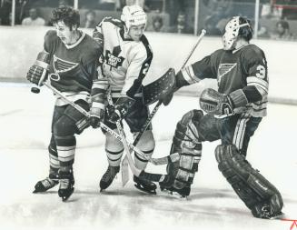 Getting repairs from trainer Joe Sgro is Leaf defenceman Rod Seiling,  victim of a wild swing from stick of Flyers' Bobby Clarke in Saturday  night's ga() – All Items – Digital Archive 