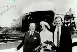 Birth of a ship: Senior Canadian statesman Paul Martin (left in insert) watched as his namesake freighter sent Collingwood spectators scrambling for