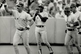 One, two, three, four...Don Mattingly leads a parade of Yankees across the plate after pounding a grand slam halfway to Etobicoke in the second inning(...)