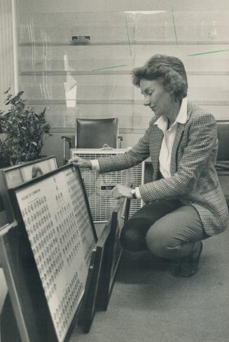 Closing up shop: New Democrat MP Lynn McDonald looks at a Parliament 'class picture' as she cleans out her office yesterday after losing her Broadview-Greenwood seat