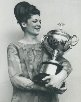 Top athlete is honored. Gymnast Susan McDonnell, of Toronto, Pan-American Games gold medallist, holds Norman Craig trophy she won as top female athlet(...)