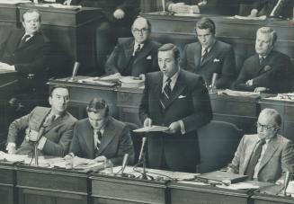 A $4.2 Billion budget, aimed at creating new jobs, is presented at Queen's Park yesterday by Provincial Treasurer Darcy MaKeough. Listening are, front(...)