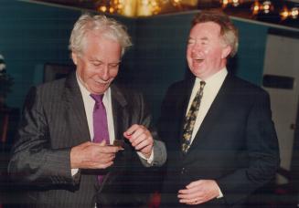 Canadian author W. O. Mitchell, left, reaches for his snuff while External Affairs Minister Joe Clark roars with laughter at a tribute yesterday honor(...)