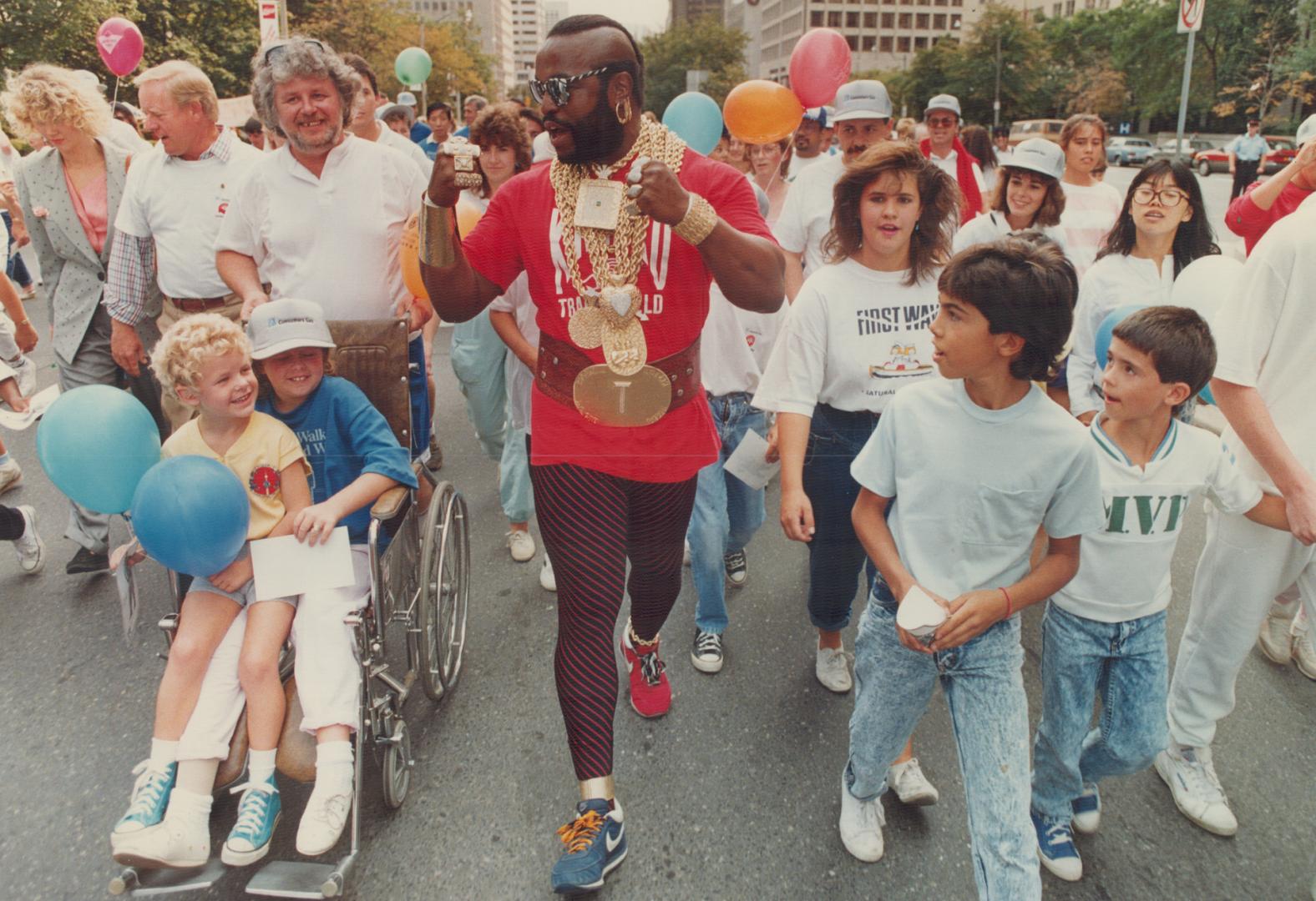 Television star Mr. T. joins in the United way walkathon through downtown Toronto yesterday with 9-year-old Sarah Whiting, left, and her brother Andre(...)