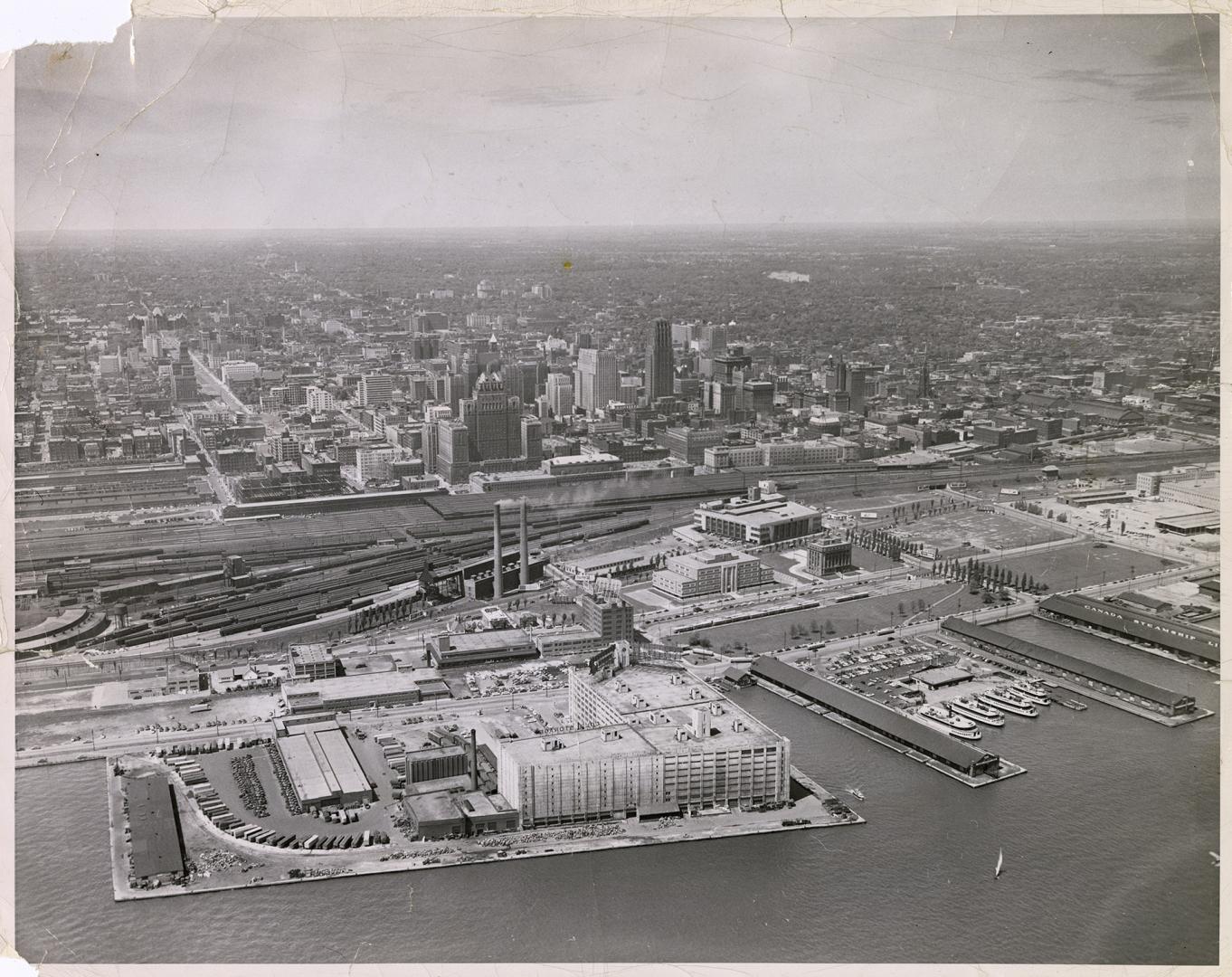 Image shows an aerial view of the Harbour buildings and further on into the city.