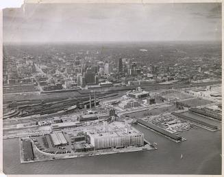 Image shows an aerial view of the Harbour buildings and further on into the city.