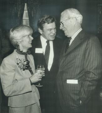 Helping a friend, John Munro, centre, head of the Canadian Transport Commission, and his wife Lily joked with Walter Gordon, a former Liberal finance (...)
