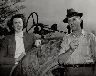 Hon. Harry Nixon, sworn in today as premier of Ontario, is shown here at work on his farm at St. George with his daughter and expert helper in the fie(...)