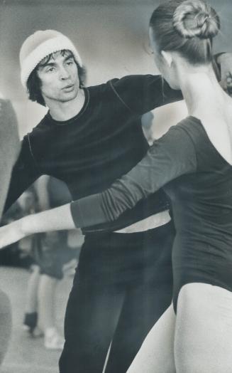 Nureyev, concentrating intensely, gives instruction to corps de ballet dancer Katherine Joyner during rehearsals