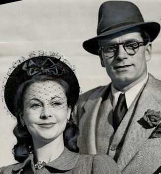 Birthday honors announced by the King included a knighthood for Laurence Olivier British actor seen with his wife