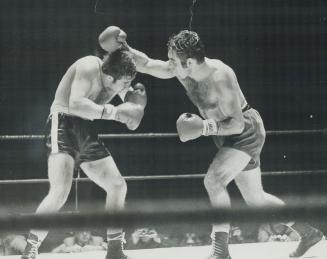 Donato Paduano of Montreal (left) had a real handful in Colin Fraser of Mississauga during last night's 10-round main event at Maple Leaf Gardens. [Incomplete]
