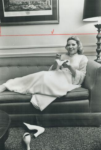 Singer Patti Page relaxes in her suite at Royal York Hotel, Needlepoint is hobby she started when she tried to give up smoking