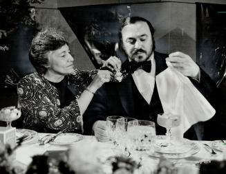A night to remember, Georgina Madott, president of the Women's Committee of Columbus Centre, makes an adjustment to Luciano Pavarotti's boutonniere at(...)