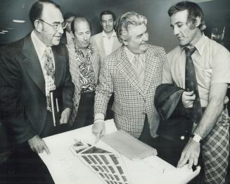 Jacques Plante (right), former Leaf goalie and now coach-general manager of Quebec Nordiques of World Hockey Association, looks at plans for sports co(...)