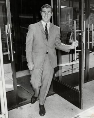 One has dollars . . . Leafs' Bob Pulford leaves his bank in Toronto after checking to see if he can afford a $500 fine. He won't need to pay it, though, since he reported today