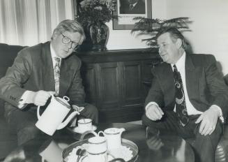Howdy, Ralph. Ontario New Democrat Premier Bob Rae pours coffee in his office today for his Alberta counterpart, Ralph Klein. The Tory westerner's on (...)