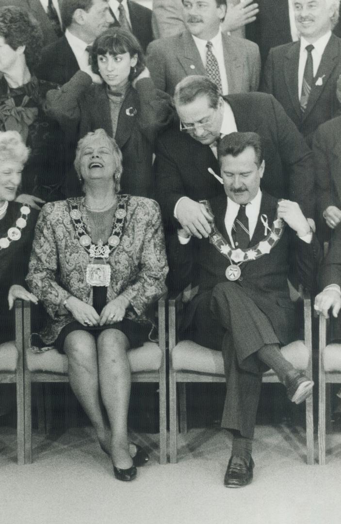 Chains of office: Alan Tonks gets some help to begin another term as Metro chairman, while Toronto Mayor June Rowlands laughs with her seatmate
