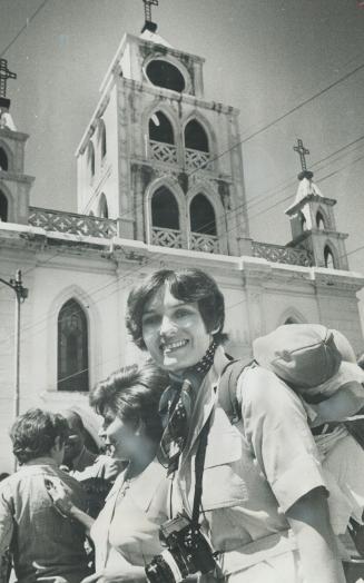 Margaret Trudeau, above with son, Michel, on her back, tours Caracas, Venzuela, during recent Latin American trip