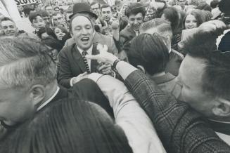 Admiring hands reached out toward Prime Minister Pierre Elliott Trudeau, trying to shake his hand today as enthusiastic crowd of more than 5,000 jamme(...)