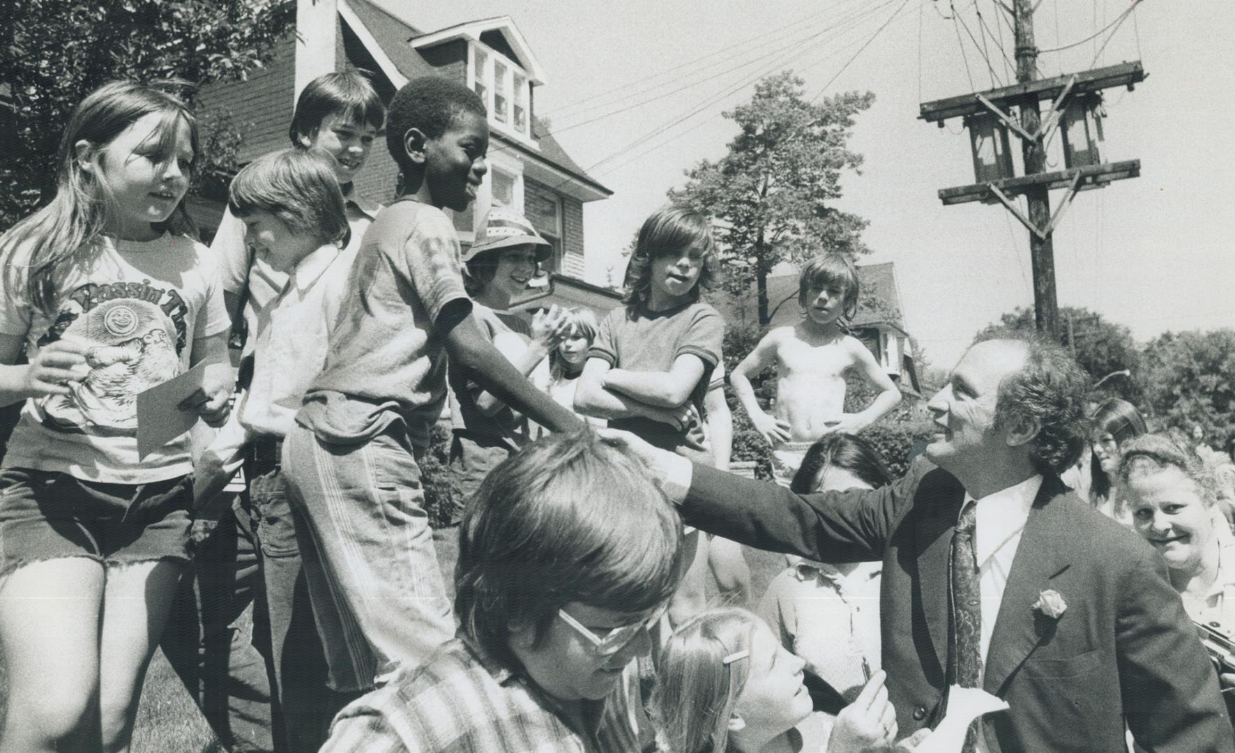 Too young to vote, young citizens flock around Prime Minister Trudeau as he takes a stroll down Waverley Rd