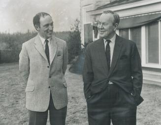 The next tenant of 24 Sussex Dr., Pierre Elliott Trudeau, and the present resident, Prime Minister Lester Pearson, tour the grounds of the gray stone (...)