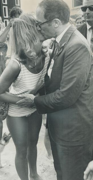 A kiss is planted on Prime Minister Pierre Trudeau's cheek by Mrs