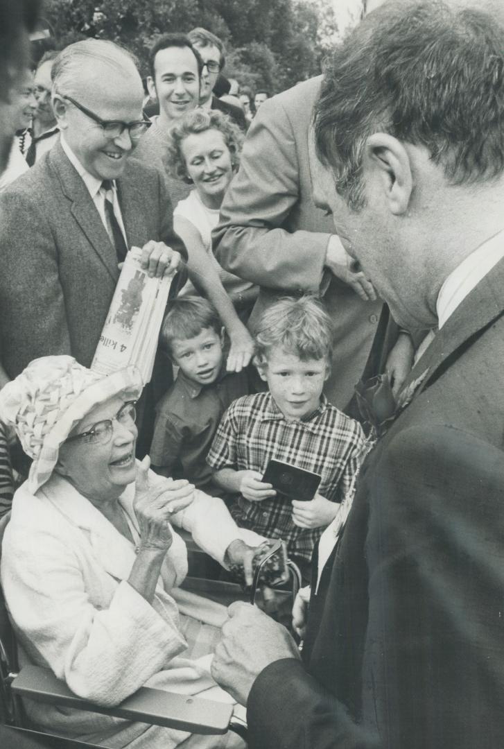 A woman in a wheelchair chats with Prime Minister Pierre Elliott Trudeau on Centre Island where the Prime Minister attended a Liberal party picnic yesterday