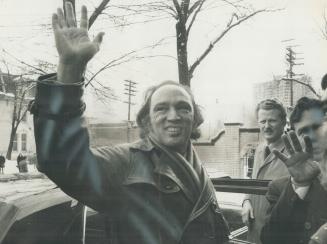 Prime minister Pierre Trudeau waves to people in building near the COSTI Education Centre on Beverely St