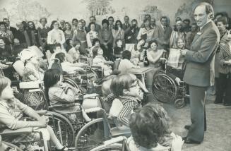 Grinning benignly, Prime Minister Pierre Elliott Trudeau speaks to the patients at Bloorview Children's Hospital for chronically disabled children in Toronto today