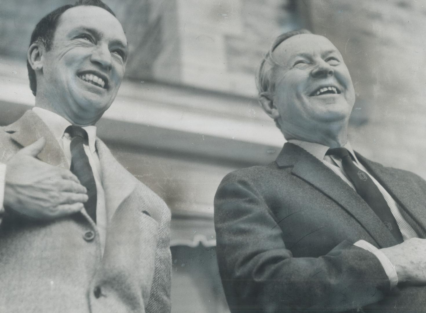 Two friends ham it up during a great moment in Canadian history