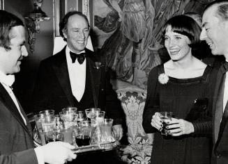 Brussels: Pierre and Margaret Trudeau laugh with Belgian Prime Minister Leo Tindermans(R) as drinks are served by waiter(L) prior to a dinner IO/23 at the Palais d'Egmont