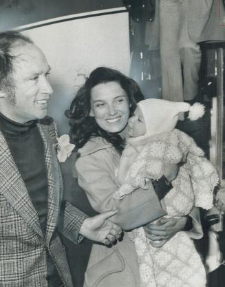 Baby Justin sticks out his tongue at his father, Prime Minister Pierre Trudeau, from his mother's arms as the family arrives at Toronto International (...)