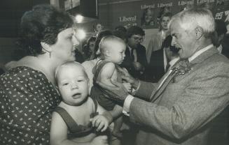 Vote for me: Prime Minister John Turner plays with two tots during a campaign stop in Chatham yesterday as the infants' mothers look on