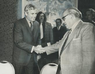Finance Minister John Turner, right, and William McGregor, Canadian Labor Congress vice-presdent, shake hands at Toronto meeting yesterday. Turner tri(...)