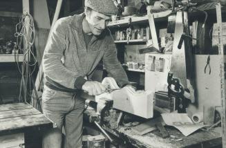 Marlboro coach Bill White relaxes working at his hobby, making pinewood furniture, in his garage