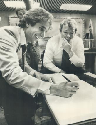 Actor Henry Winkler, better known as The Fonz, signs the guest book at Toronto City Hall toay as Toronto Mayor David Crombie looks on