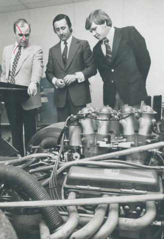 Walter Wolf (left) studies Can-An engine