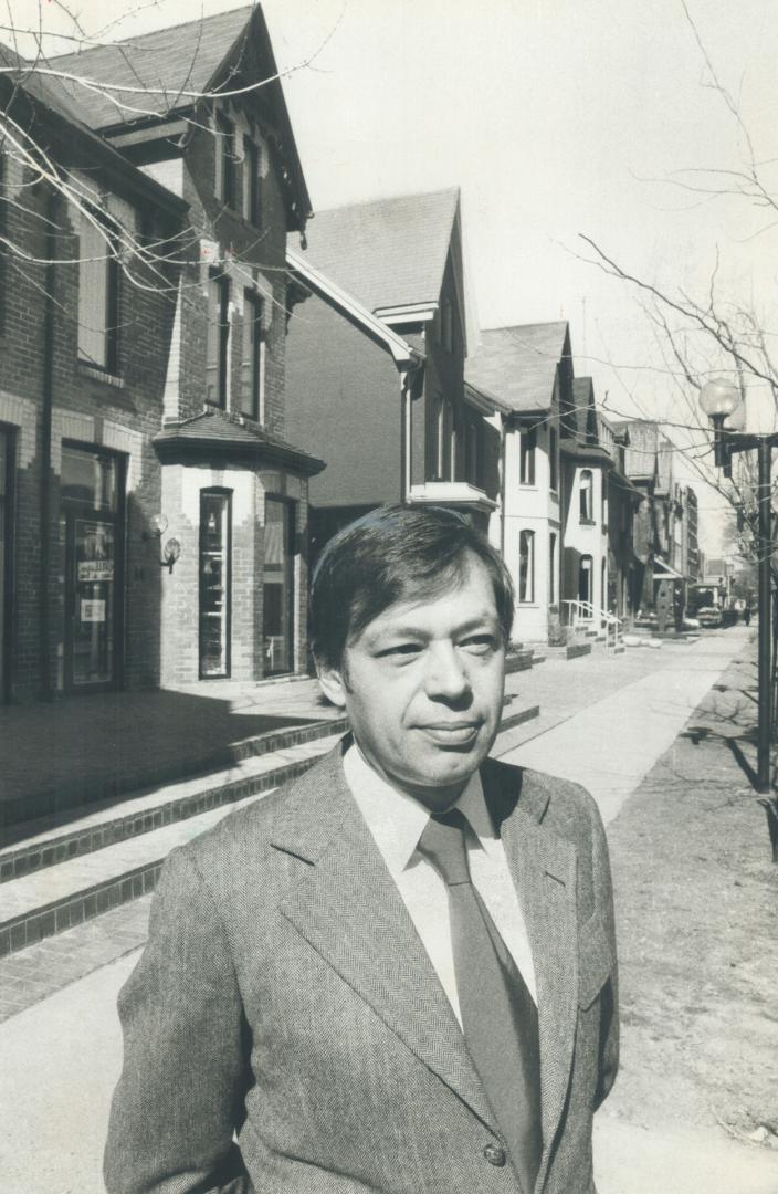 Developer Richard Wookey stands in front of old houses on Hazelton Ave