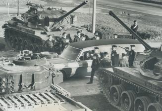 Arch of tank guns was formed by four massive Centurion tanks stationed by the side of road yesterday as funeral cortege for Major General F. F. Worthi(...)