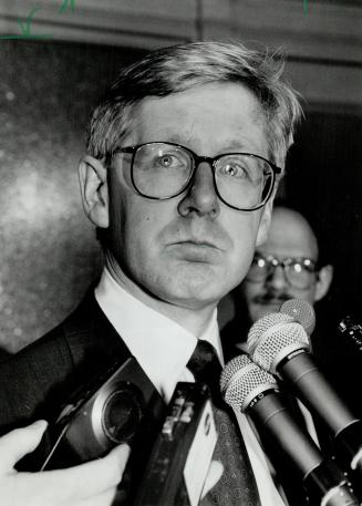Unhappy premier: Bob Rae faces reporters after accepting his health minister's resignation and ordering a probe into his social services minister's dealings