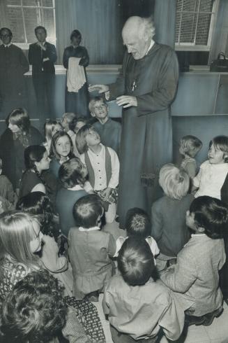 Dr. Michael Ramsey, the Archbishop of Canterbury talks to children's group at St. Thomas Anglican Church, where Ramsey delivered a sermon yesterday. T(...)