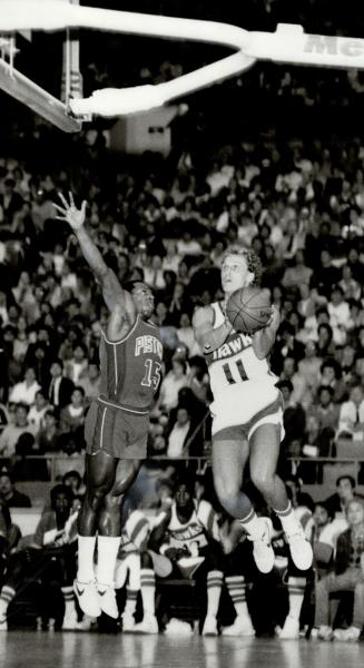 Atlanta Hawks' Jim Washington leaps and misses ball as Jim McMillian of Buffalo  Braves looks on with some surprise during last night's National Basket()  – All Items – Digital Archive Ontario