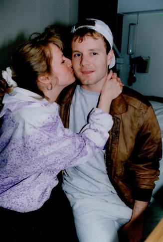 Birthday boy: Leaf goaltender Jeff Reese gets a kiss from his wife Elaine, just prior to being released from hospital yesterday, his 25th birthday