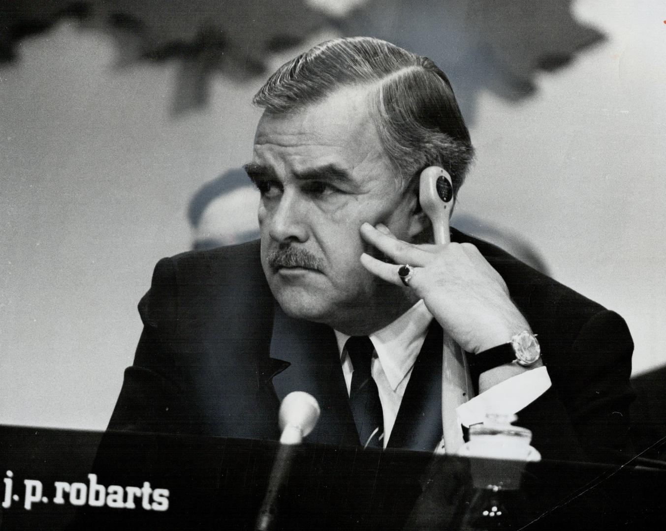 Premier Robarts, right, listening to French translation, called the four-day conference