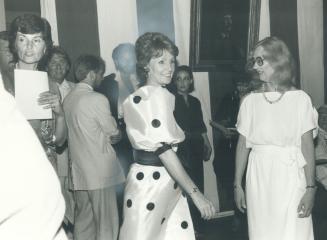 Her Excellency Lily Schreyer, above, wearing a cool white and black polka dot gown, greets guests at Canadian Fashion On Parade, held last week at Rideau Hall