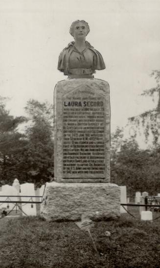 A monument to Laura Secord topped by a bust of her. Explanatory text appears on the monument (u ...