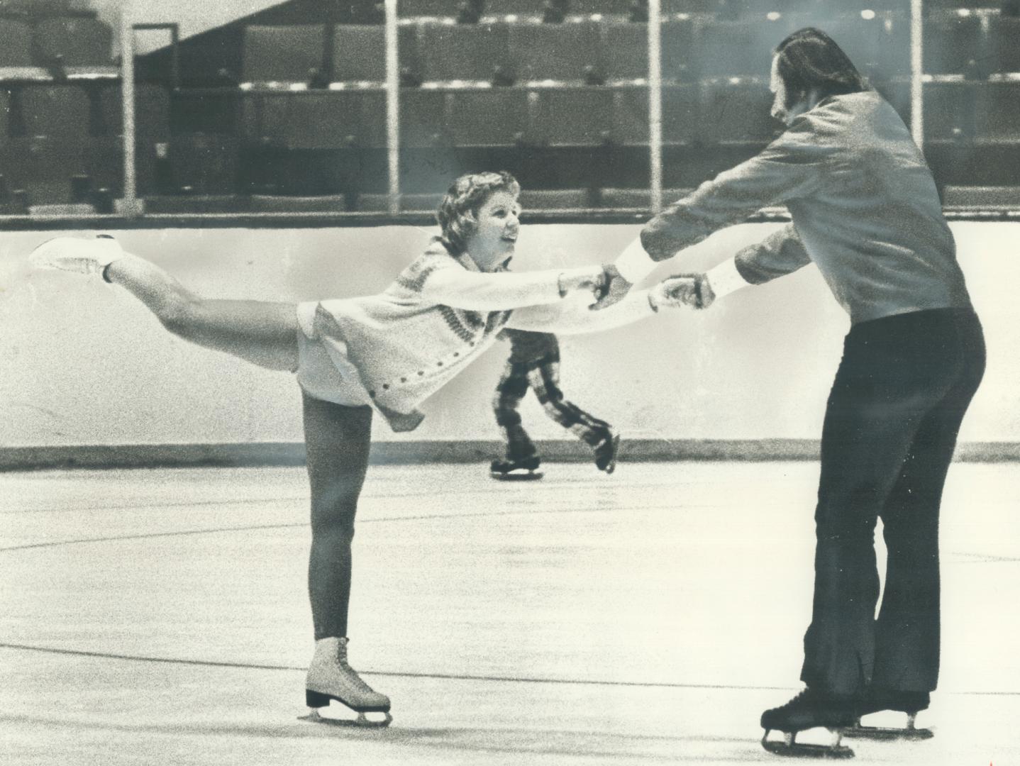 Eddie Shack, the Maple Leafs' flamboyant winger, is stationary for this instant as he guides 13-year-old Cindy Bower, daughter of former Leaf goalie, (...)