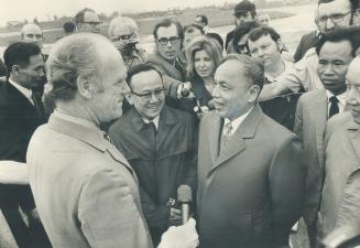 External Affairs Minister Mitchell Sharp, arriving at the Hanoi airport, is met by his North Vietnamese counterpart, Nguyen Duy Trinh (right), and an (...)